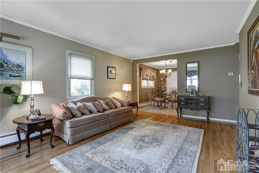 65 Tower Road Edison, NJ 08820 - Photo 5 of 14 a living room with furniture and a large mirror next to a window