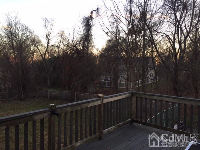 65 Tower Road Edison, NJ 08820 - Photo 9 of 14 a view of deck with trees and wooden fence