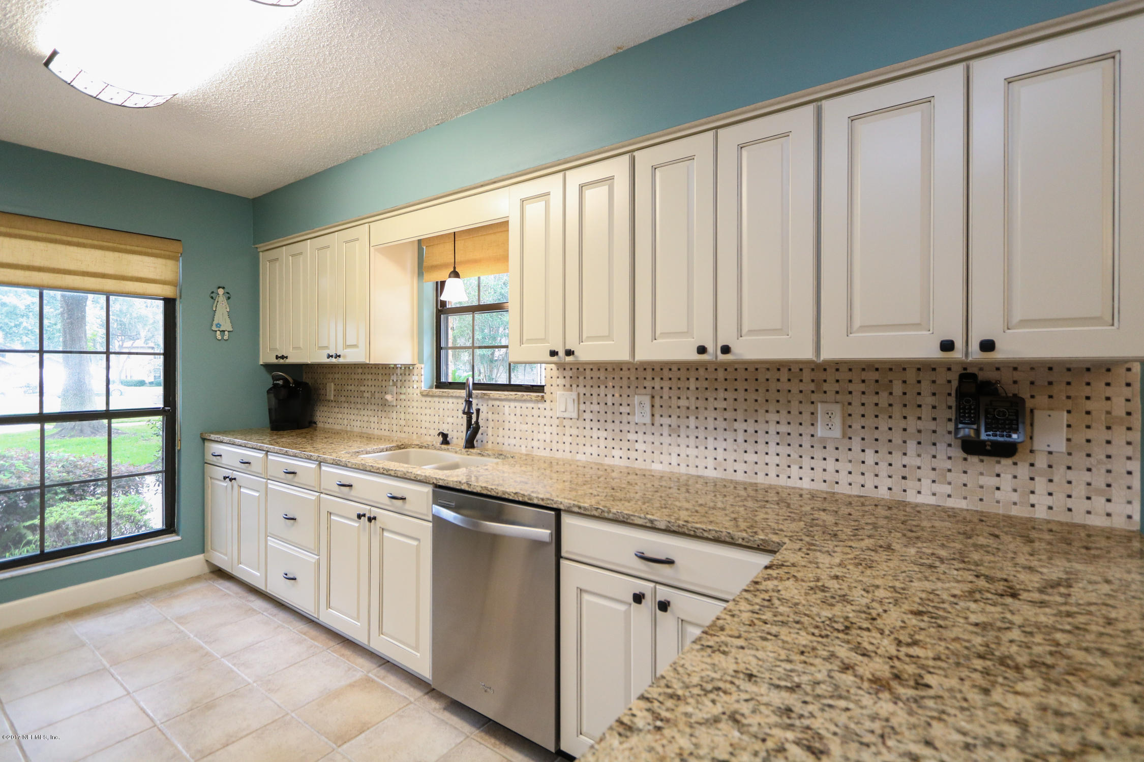 3141 Nautilus Road Middleburg, FL 32068 - Photo 14 of 43 a kitchen with stainless steel appliances granite countertop a sink and a stove