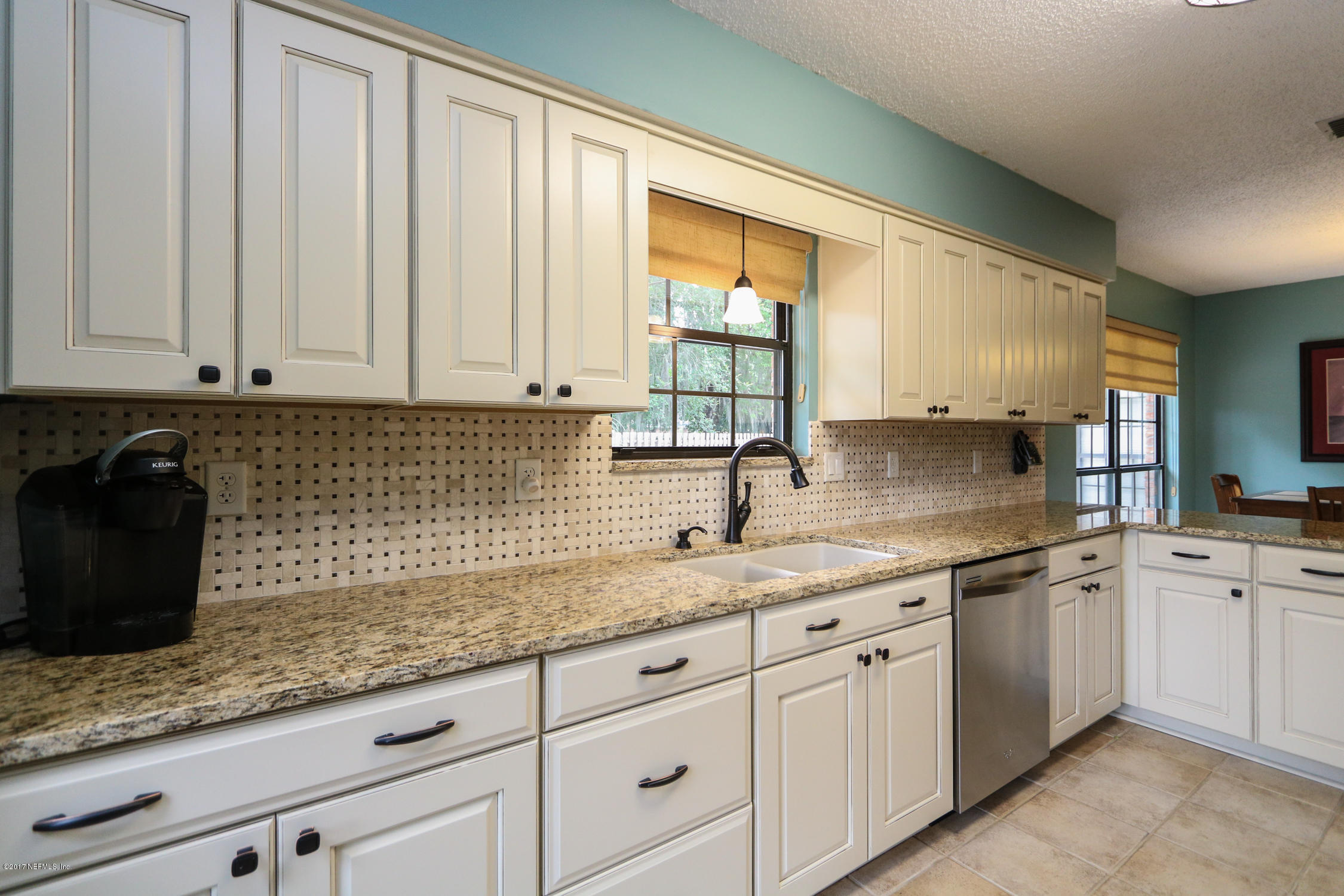 3141 Nautilus Road Middleburg, FL 32068 - Photo 15 of 43 a kitchen with granite countertop white cabinets and white stainless steel appliances