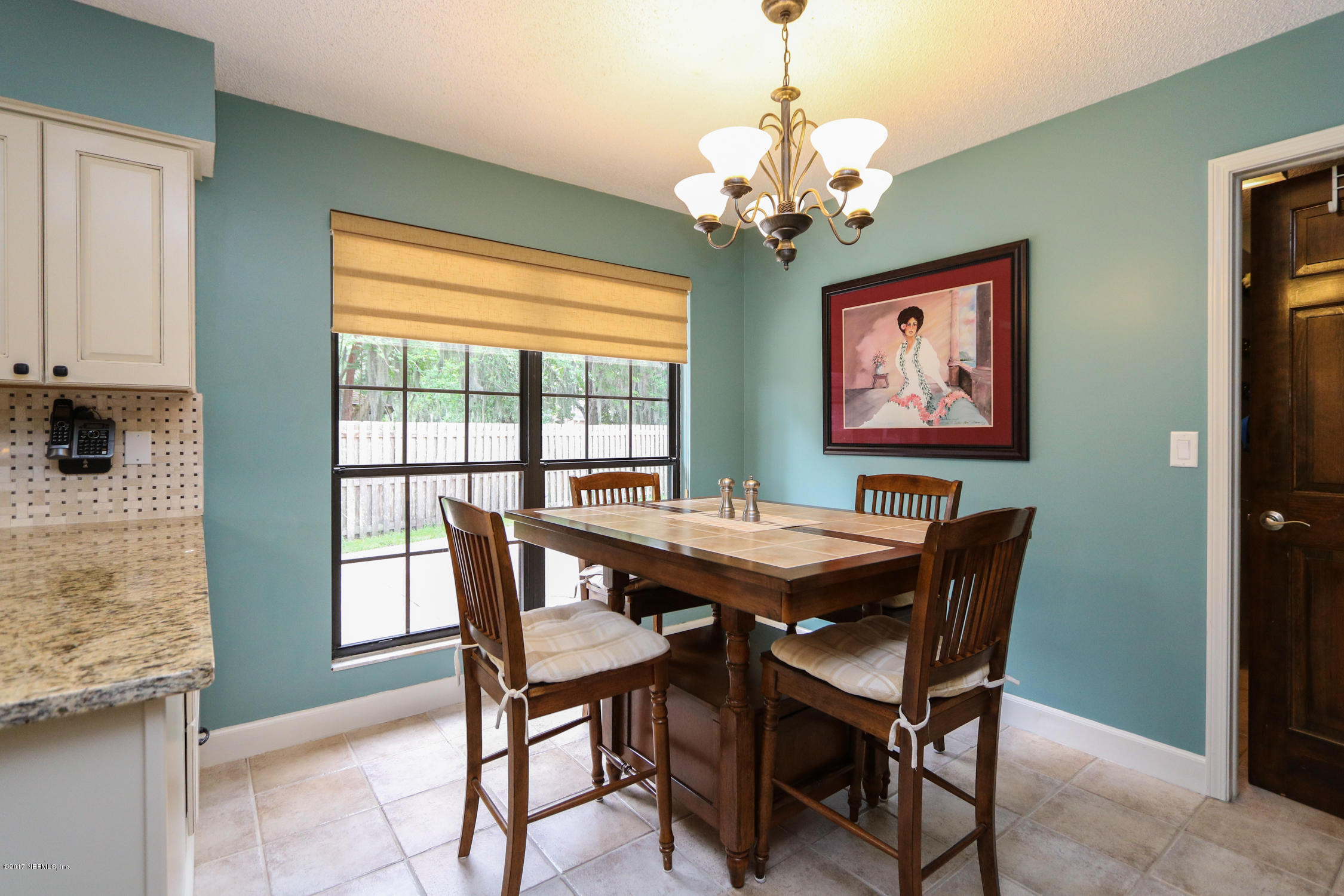3141 Nautilus Road Middleburg, FL 32068 - Photo 17 of 43 a view of a dining room with furniture a chandelier and wooden floor