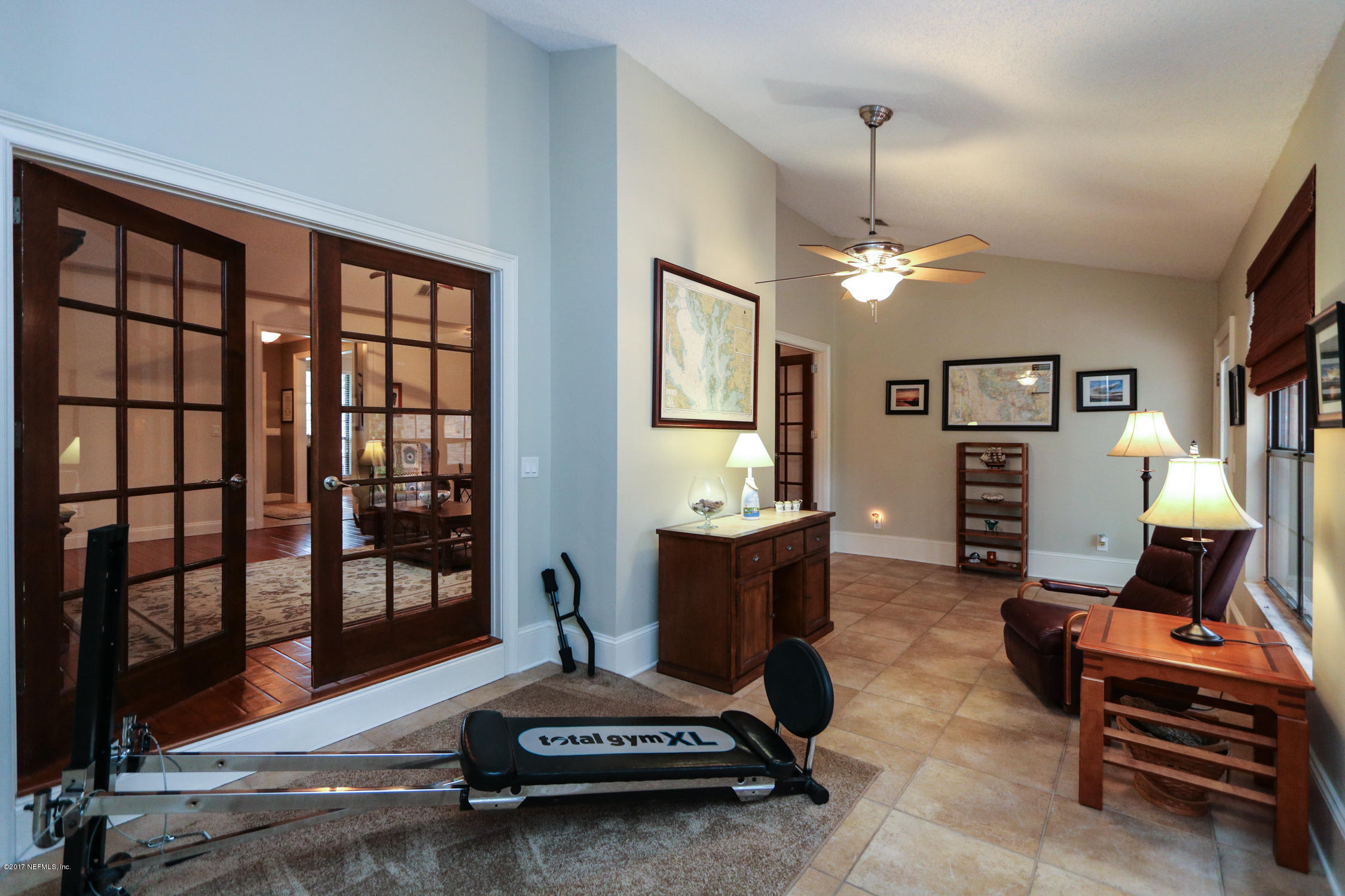 3141 Nautilus Road Middleburg, FL 32068 - Photo 18 of 43 a living room with furniture piano and a window