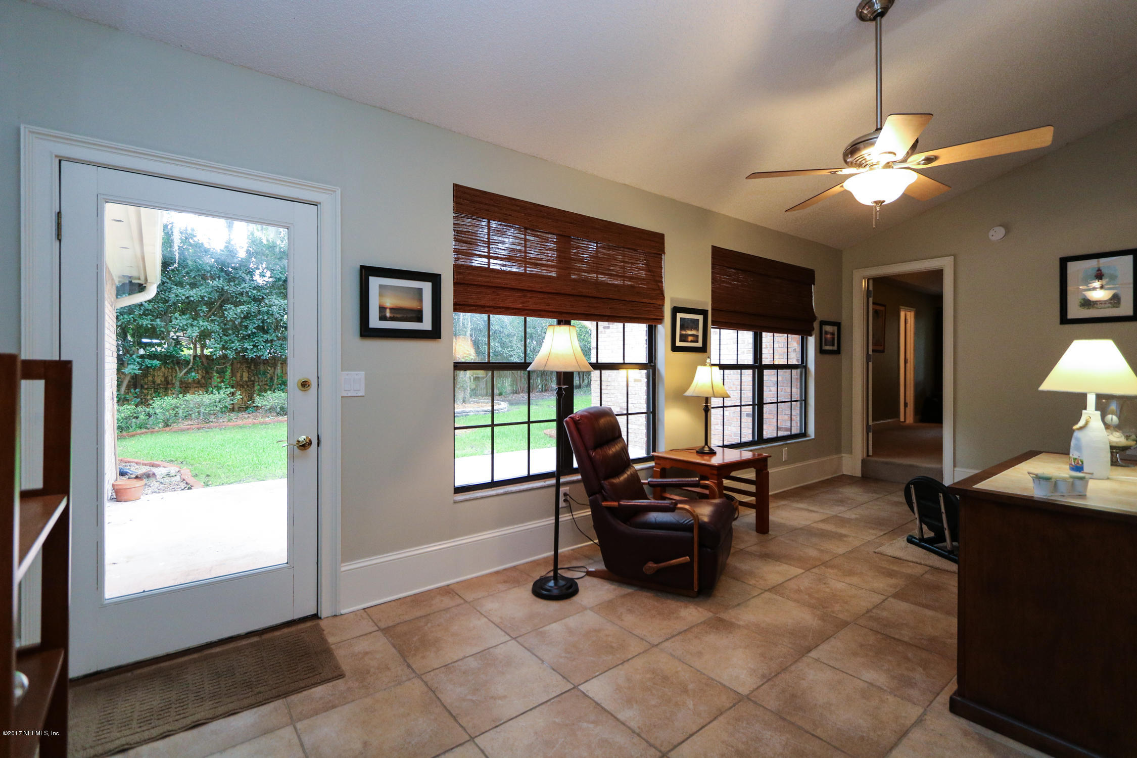 3141 Nautilus Road Middleburg, FL 32068 - Photo 19 of 43 a living room with furniture and large windows