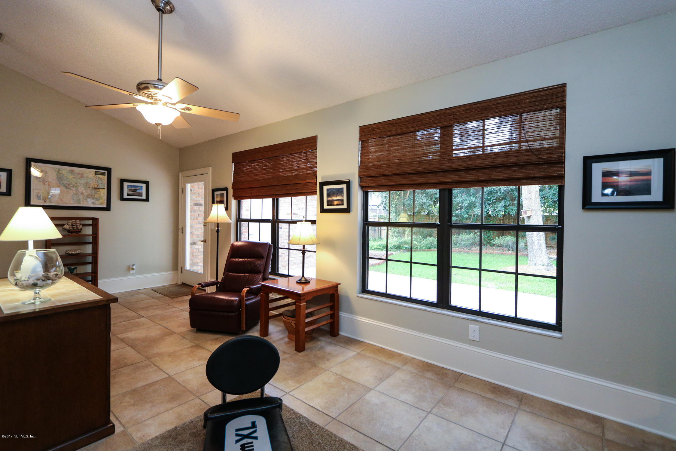 3141 Nautilus Road Middleburg, FL 32068 - Photo 20 of 43 a living room with furniture and a floor to ceiling window