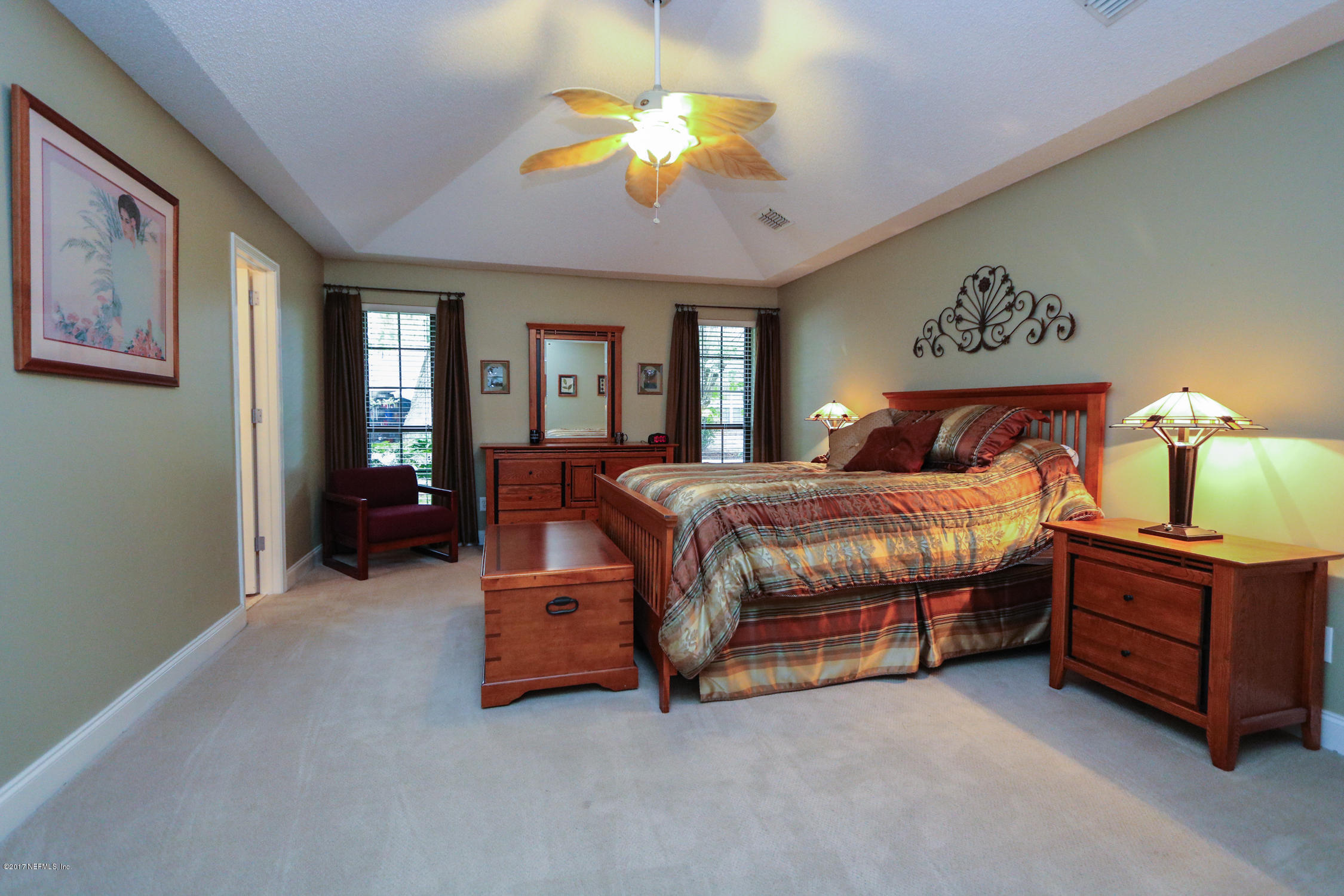 3141 Nautilus Road Middleburg, FL 32068 - Photo 22 of 43 a bedroom with a bed and a chandelier