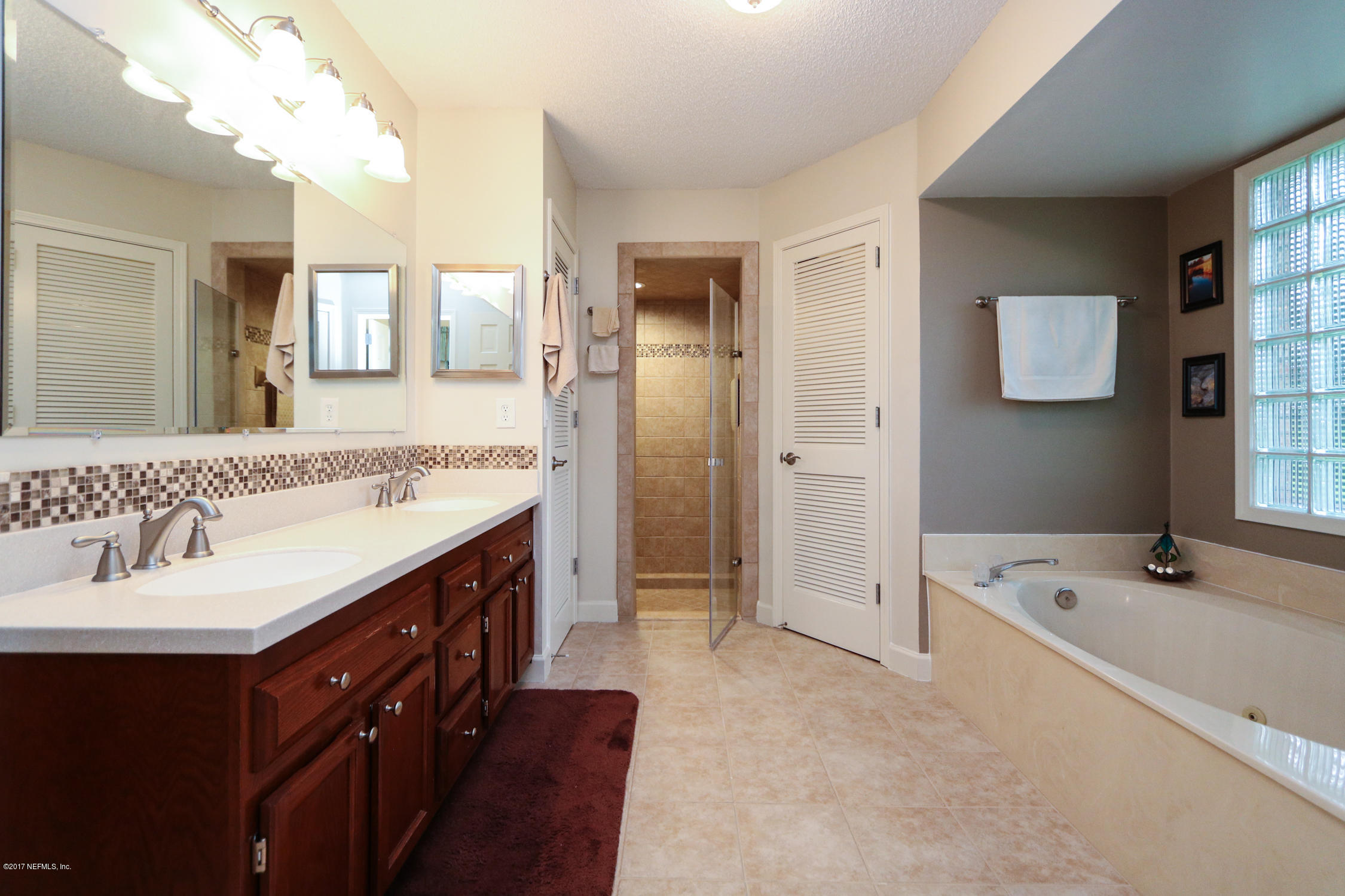3141 Nautilus Road Middleburg, FL 32068 - Photo 25 of 43 a spacious bathroom with a tub sink and mirror