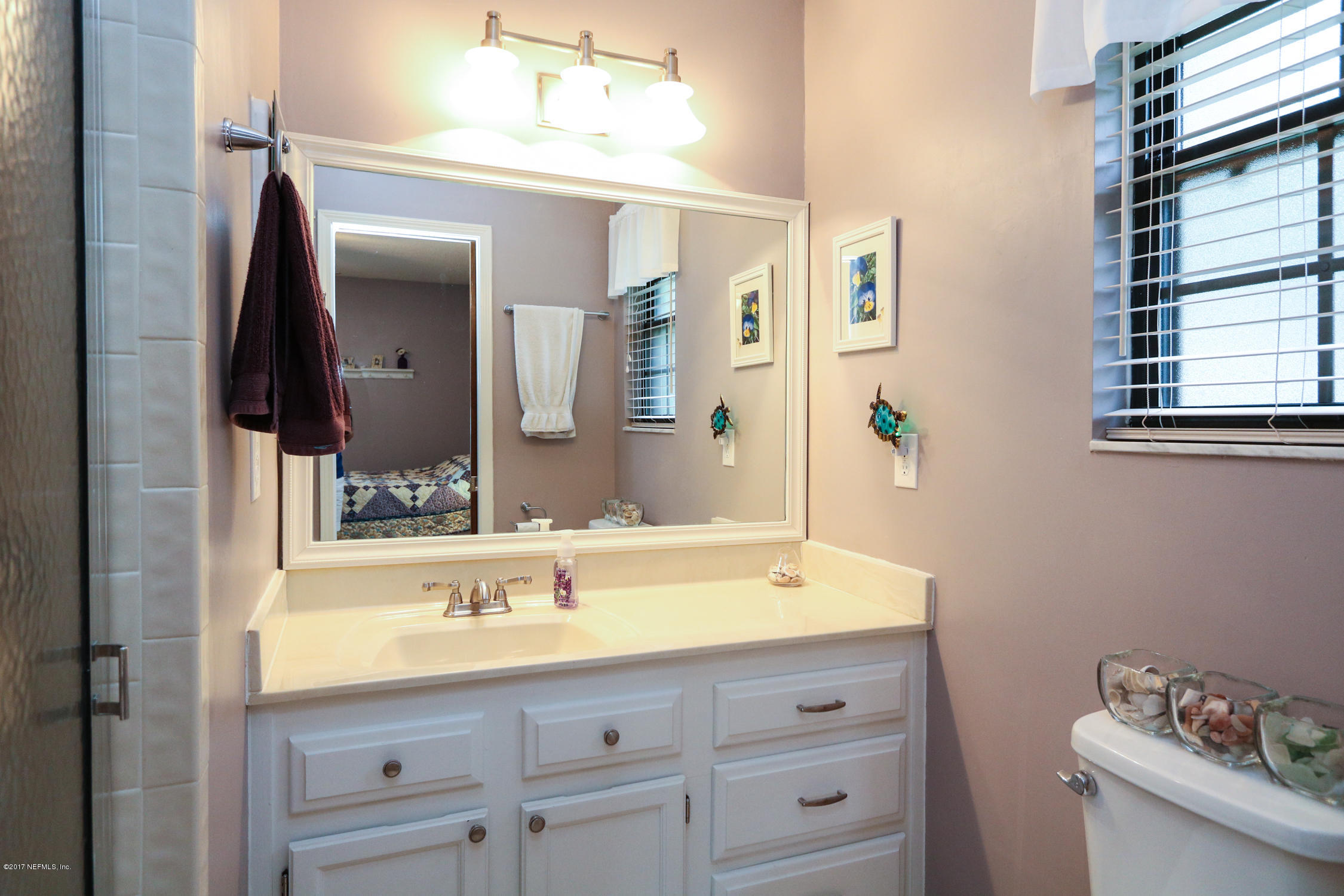 3141 Nautilus Road Middleburg, FL 32068 - Photo 30 of 43 a bathroom with a sink and a mirror