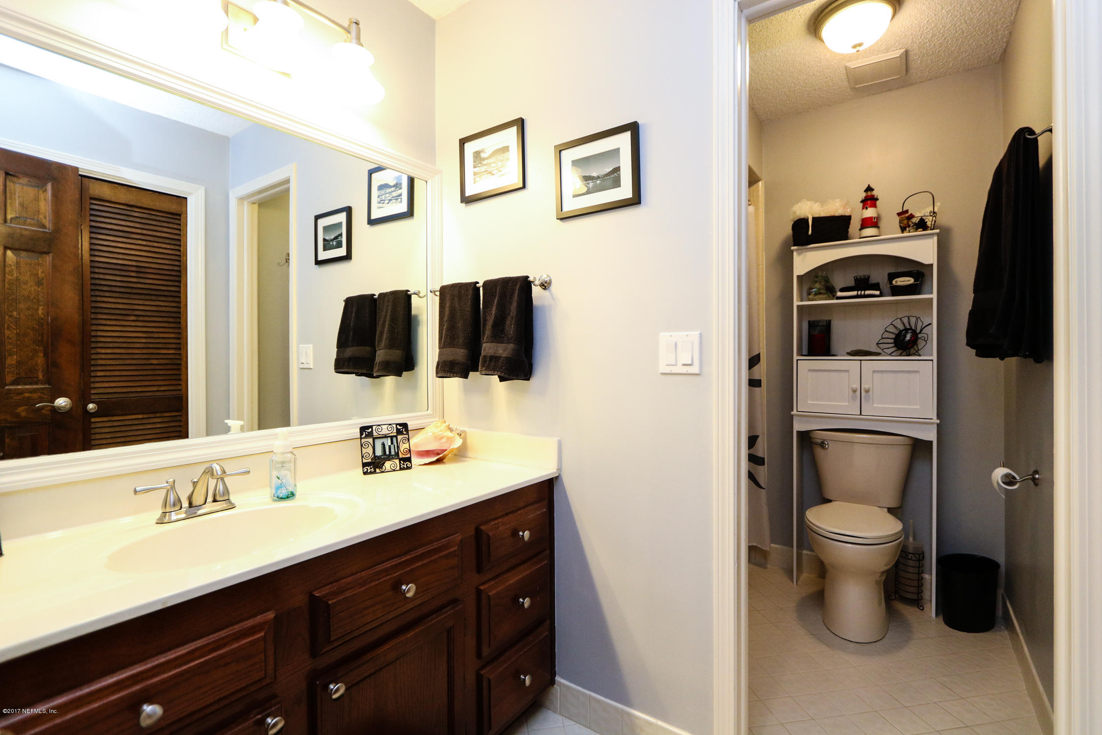 3141 Nautilus Road Middleburg, FL 32068 - Photo 33 of 43 a bathroom with a sink toilet and shower