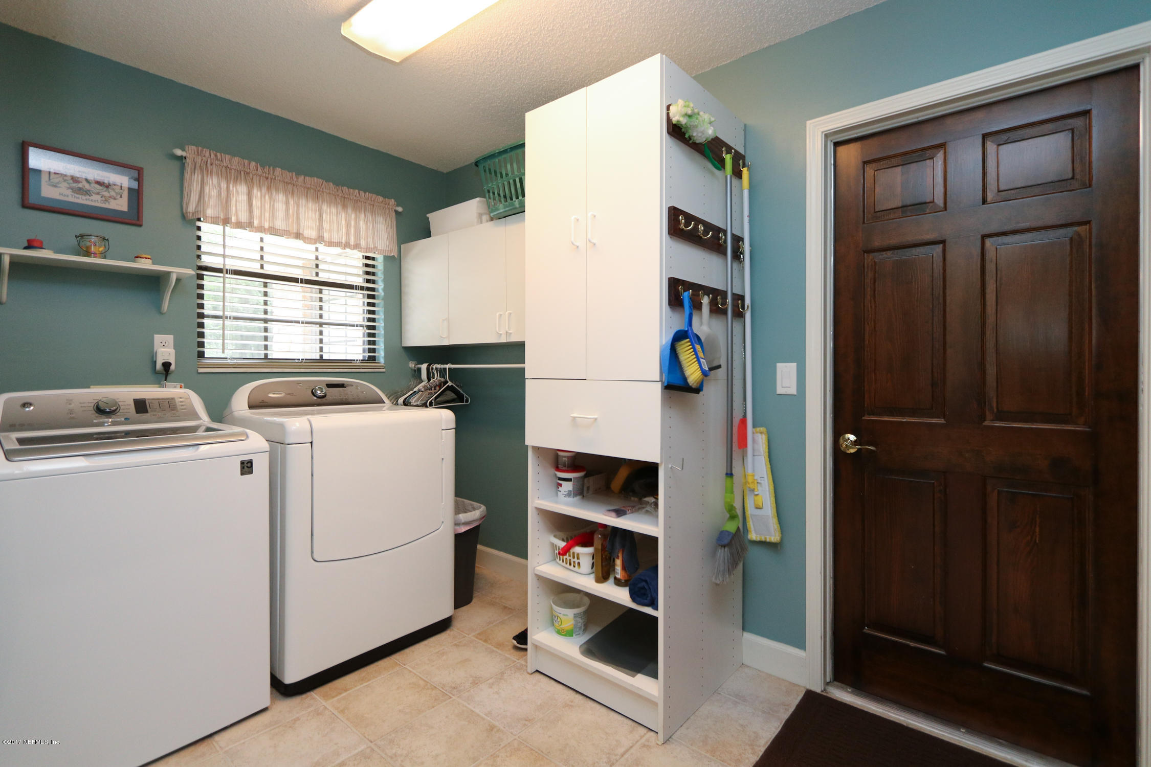 3141 Nautilus Road Middleburg, FL 32068 - Photo 34 of 43 a view of storage and utility room with washer and dryer