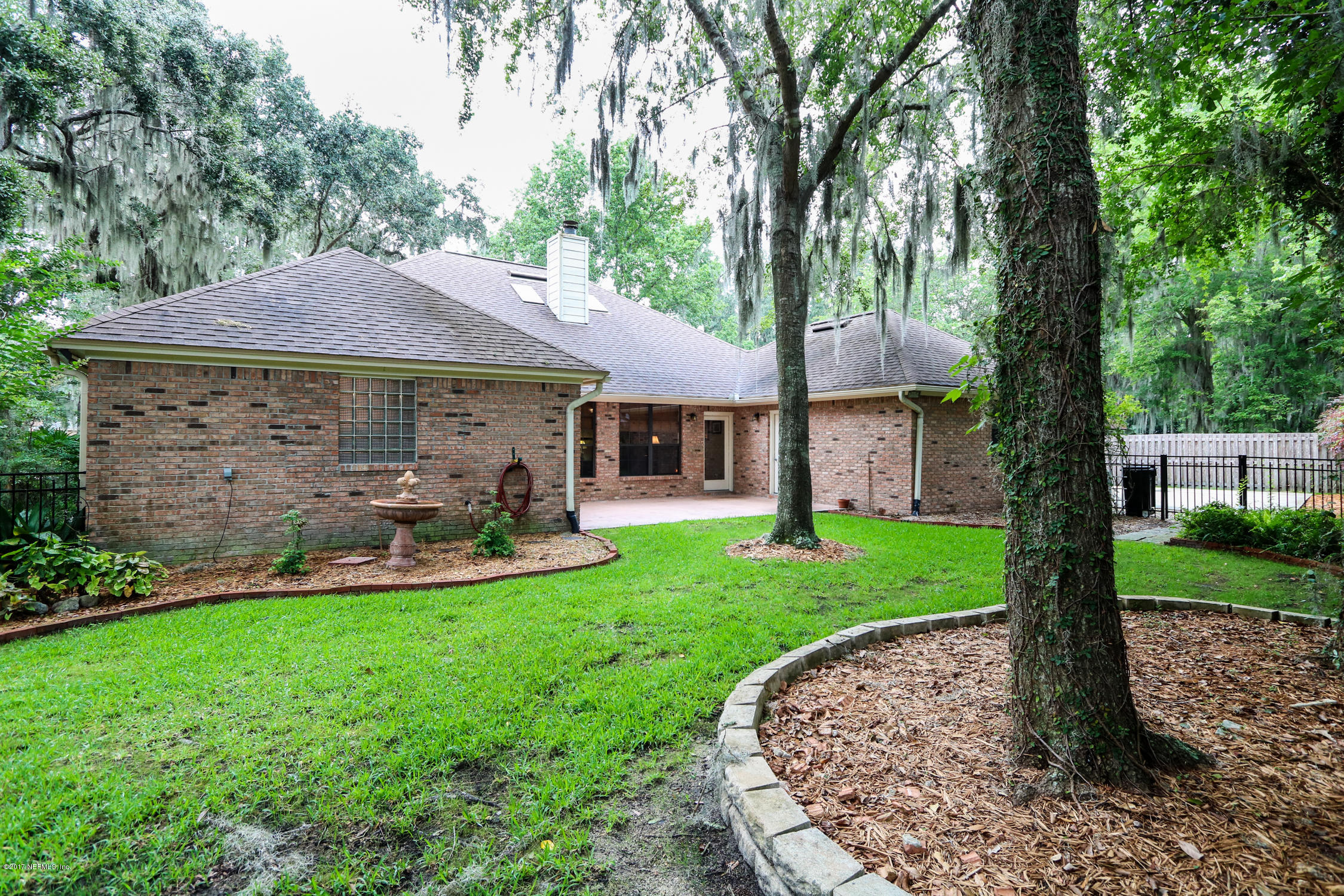 3141 Nautilus Road Middleburg, FL 32068 - Photo 40 of 43 a front view of a house with garden and trees
