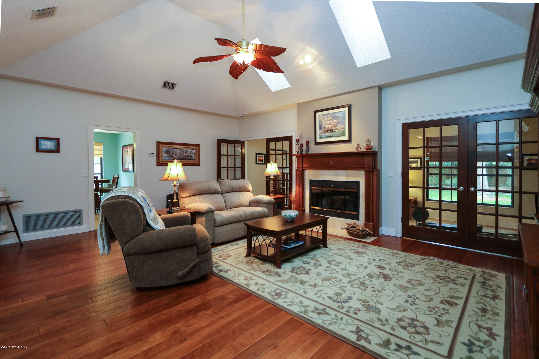 3141 Nautilus Road Middleburg, FL 32068 - Photo 6 of 43 a living room with furniture windows and a fireplace