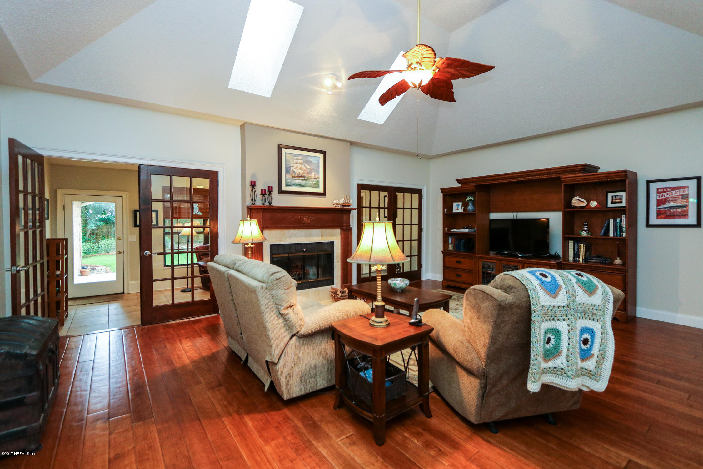3141 Nautilus Road Middleburg, FL 32068 - Photo 8 of 43 a living room with fireplace furniture and a wooden floor