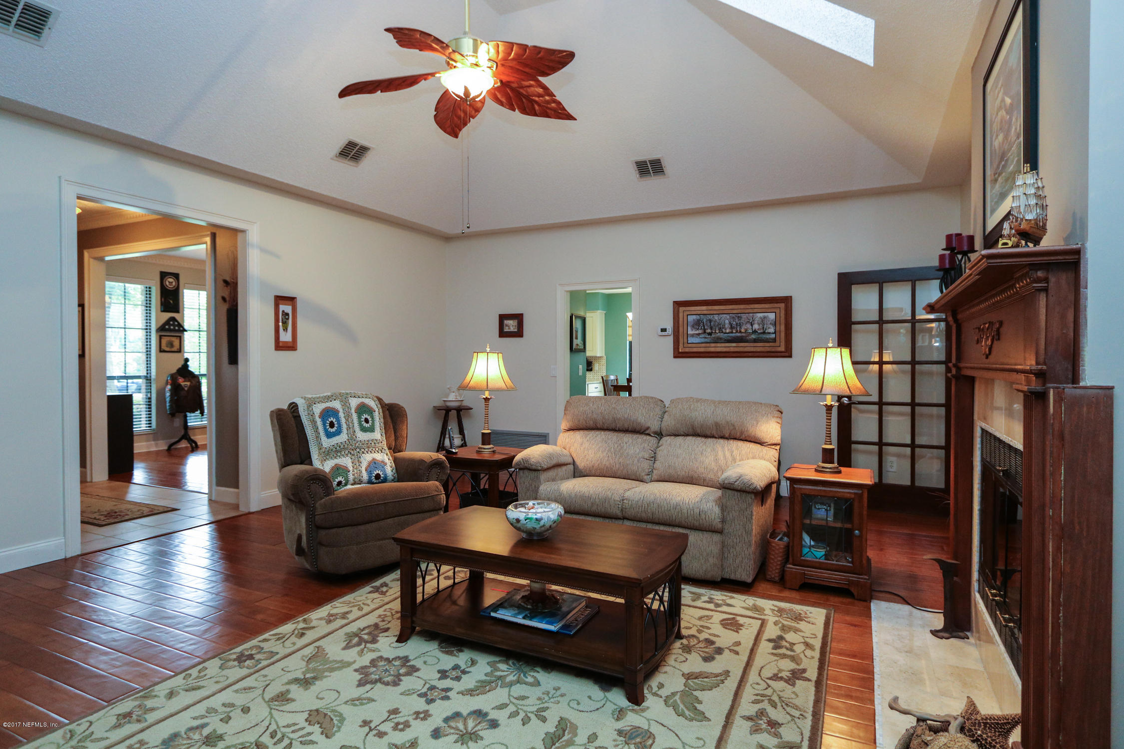 3141 Nautilus Road Middleburg, FL 32068 - Photo 9 of 43 a living room with furniture and wooden floor