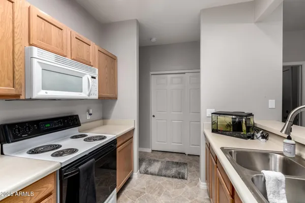 a kitchen that has a sink and a stove