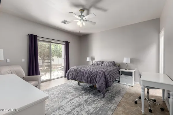 a bedroom with a large bed and a chandelier