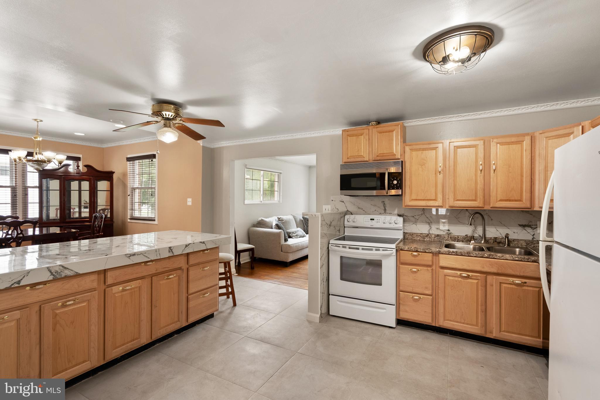 11300 Schuylkill Road Rockville, MD 20852 - Photo 12 of 55 a kitchen with a sink stove and cabinets