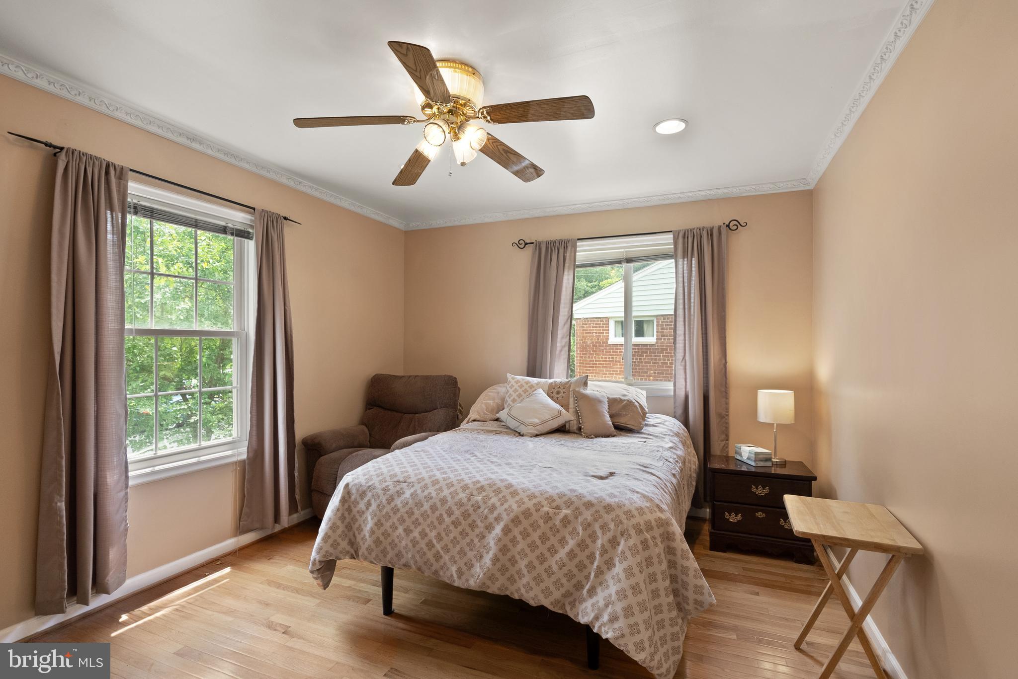 11300 Schuylkill Road Rockville, MD 20852 - Photo 22 of 55 a bedroom with a large bed chandelier and a window
