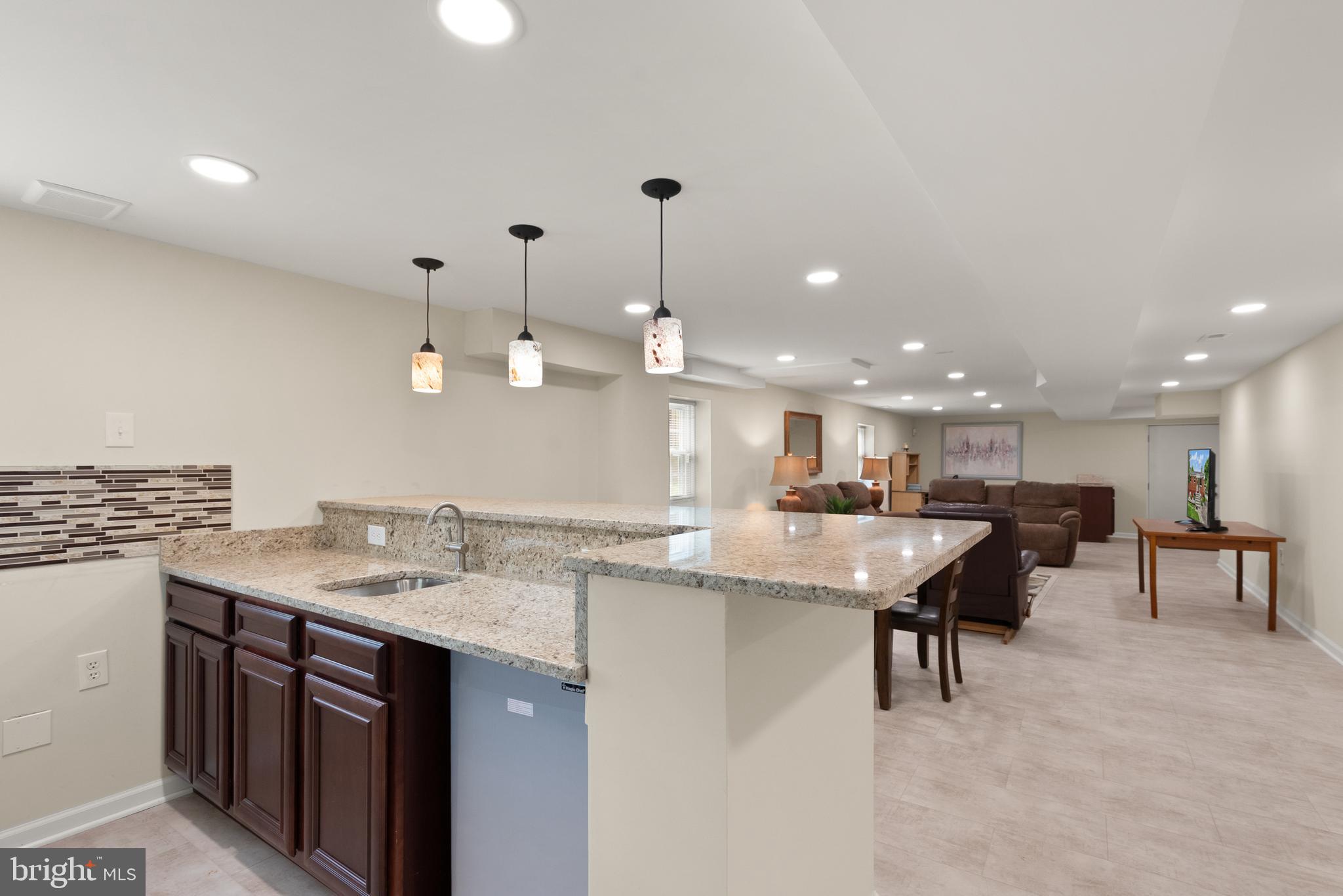 11300 Schuylkill Road Rockville, MD 20852 - Photo 32 of 55 a kitchen with a sink a counter space appliances and a dining table