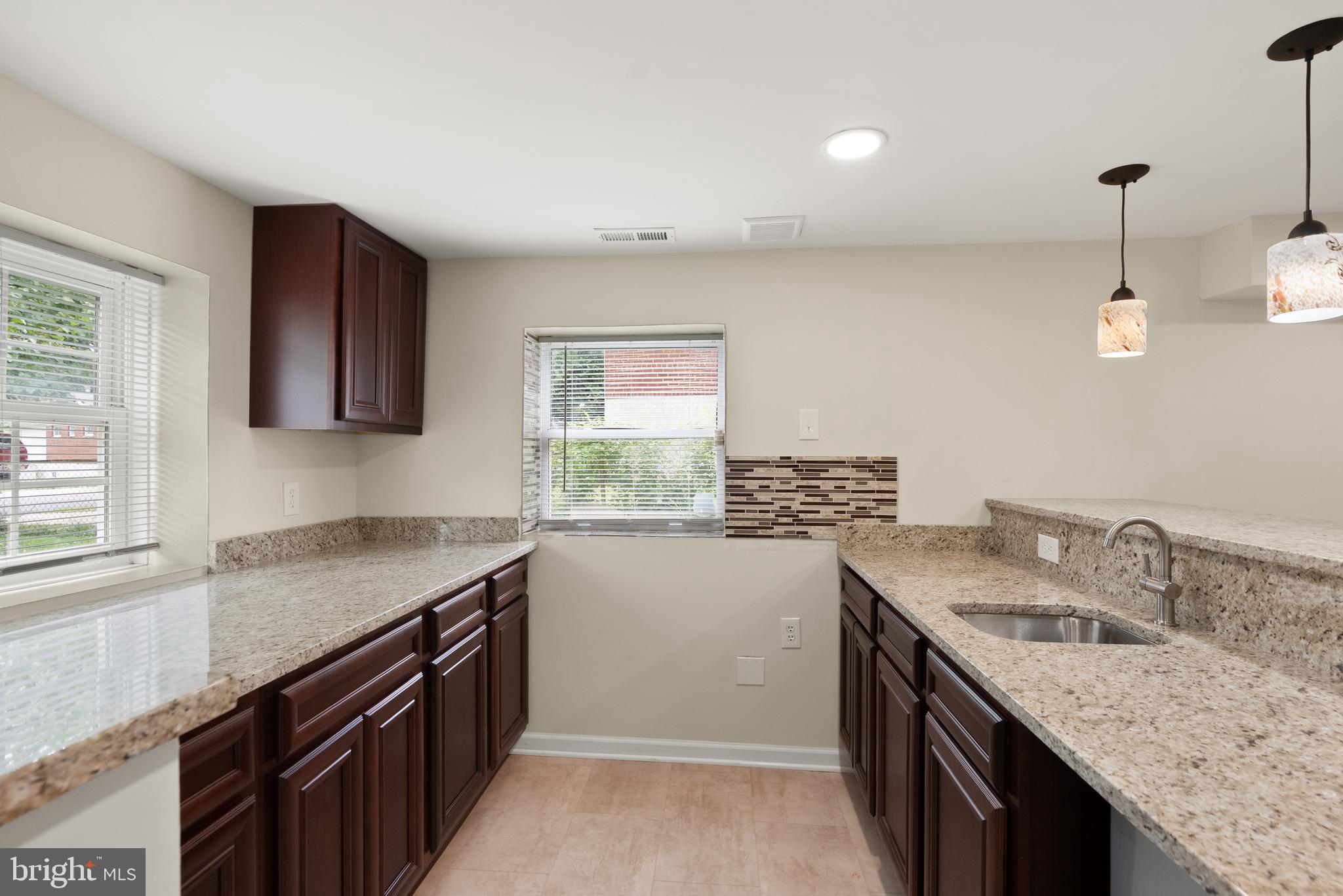 11300 Schuylkill Road Rockville, MD 20852 - Photo 33 of 55 a kitchen that has a sink a stove and a window