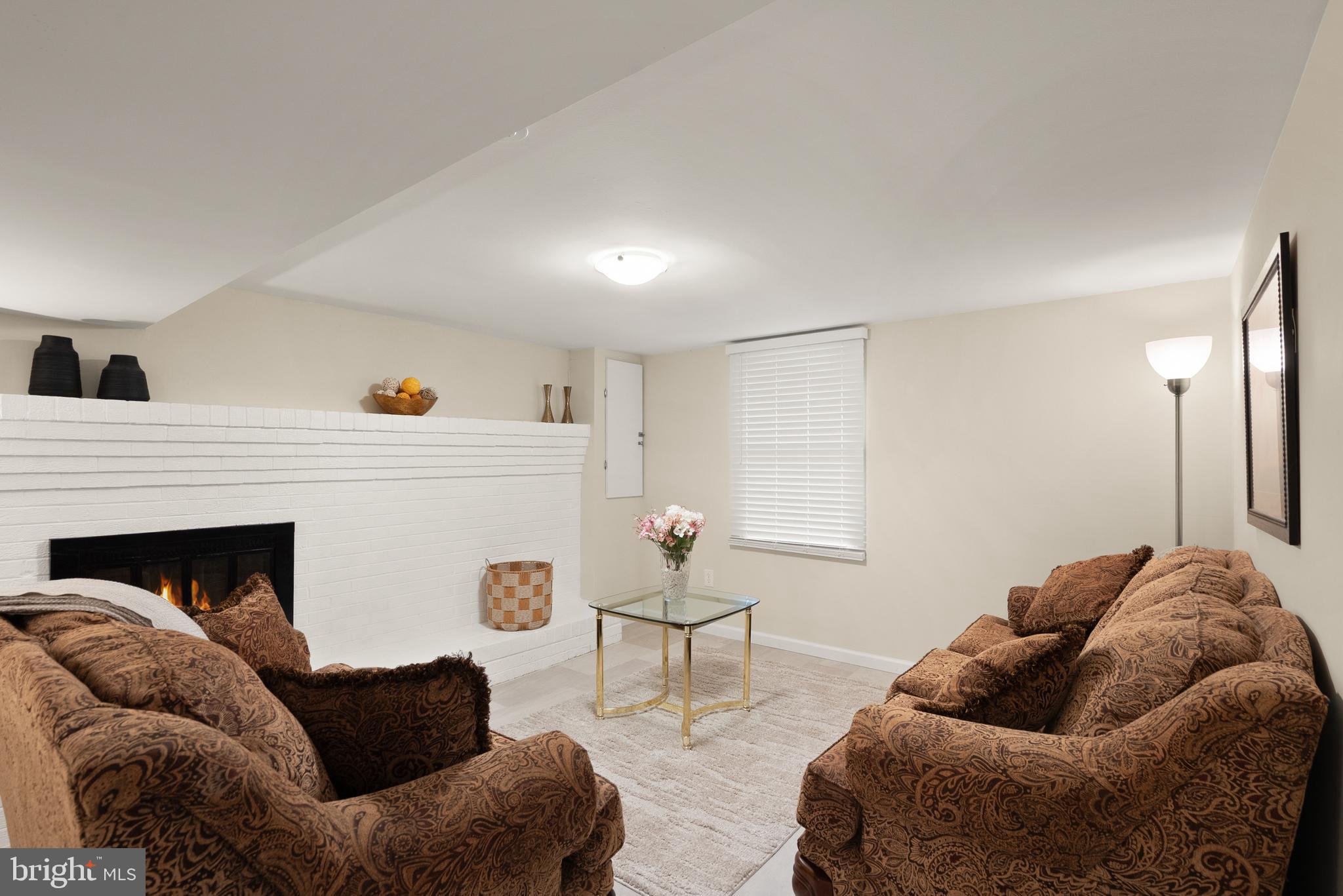 11300 Schuylkill Road Rockville, MD 20852 - Photo 44 of 55 a living room with furniture and a fireplace