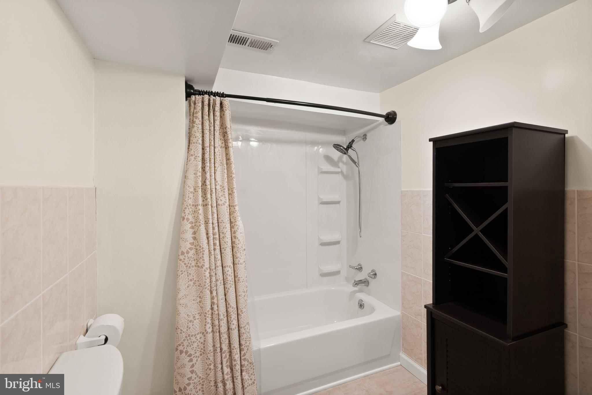 11300 Schuylkill Road Rockville, MD 20852 - Photo 48 of 55 a bathroom with a bathtub and a shower