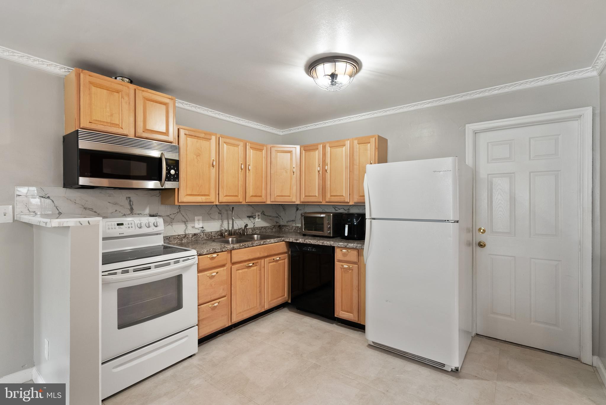 11300 Schuylkill Road Rockville, MD 20852 - Photo 8 of 55 a kitchen with a refrigerator stove and microwave
