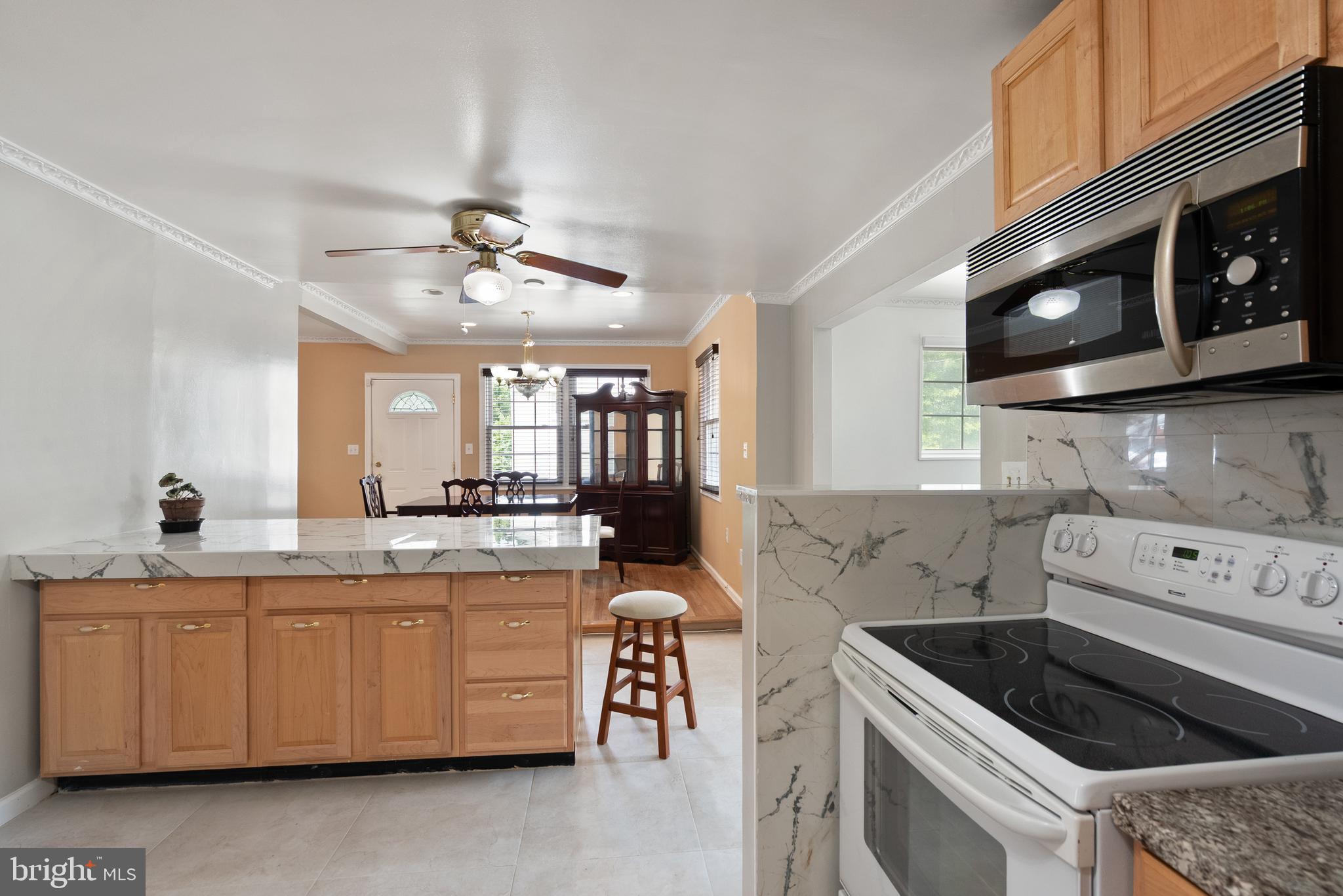 11300 Schuylkill Road Rockville, MD 20852 - Photo 10 of 55 a kitchen with a cabinets and white stove top oven