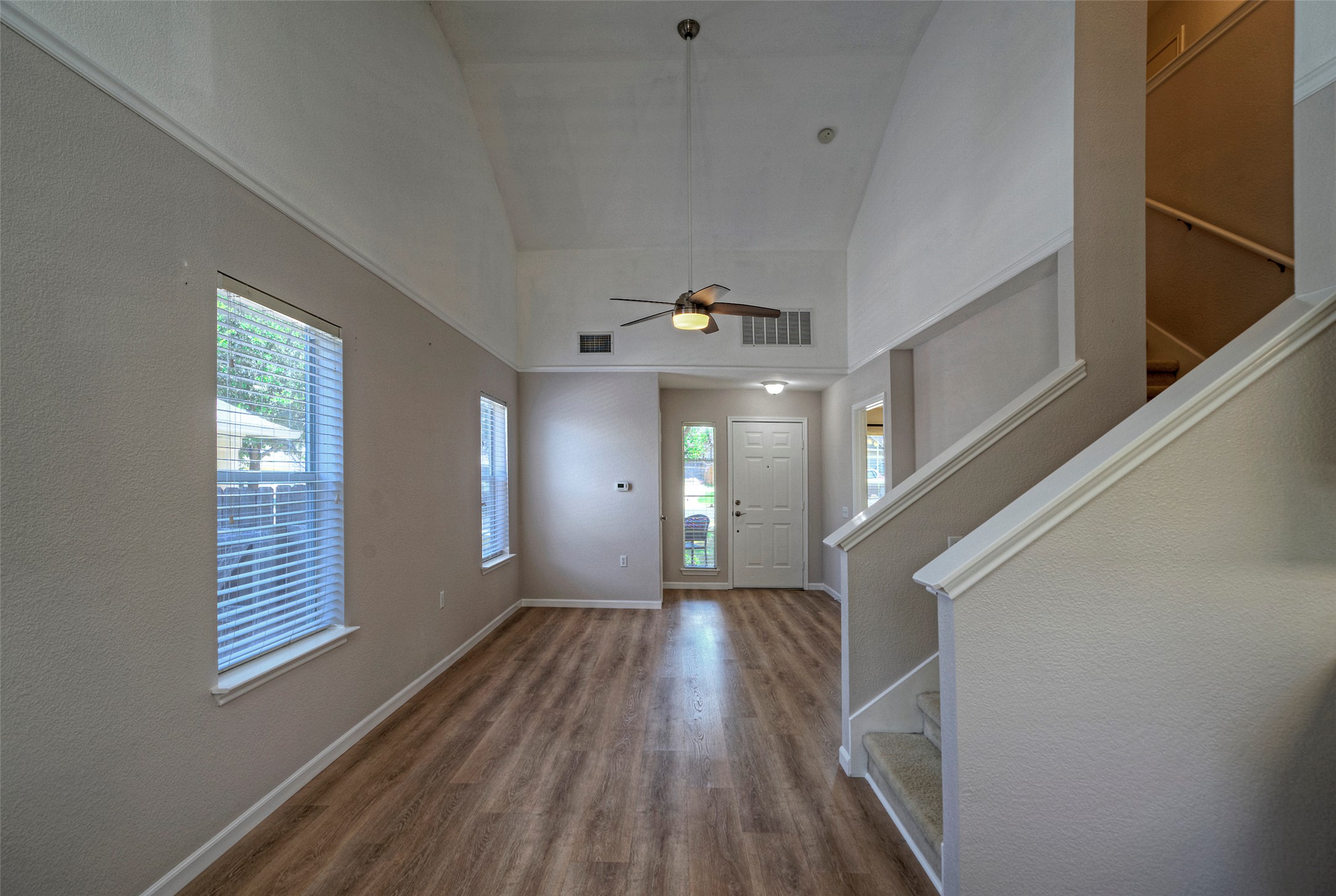 18100 Belfry Pass Manor, TX 78653 - Photo 11 of 30 a view of a room with wooden floor and staircase