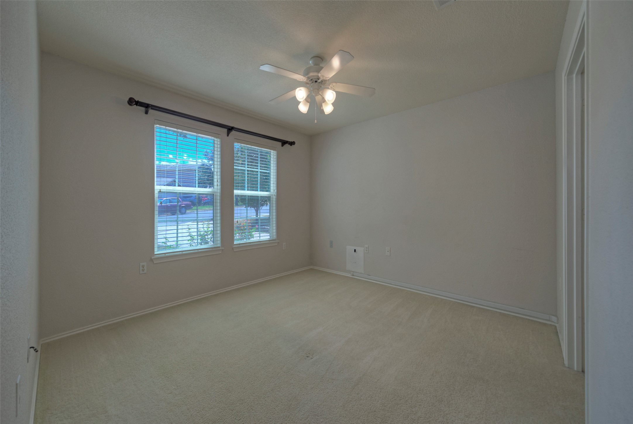 18100 Belfry Pass Manor, TX 78653 - Photo 12 of 30 an empty room with a ceiling fan and window
