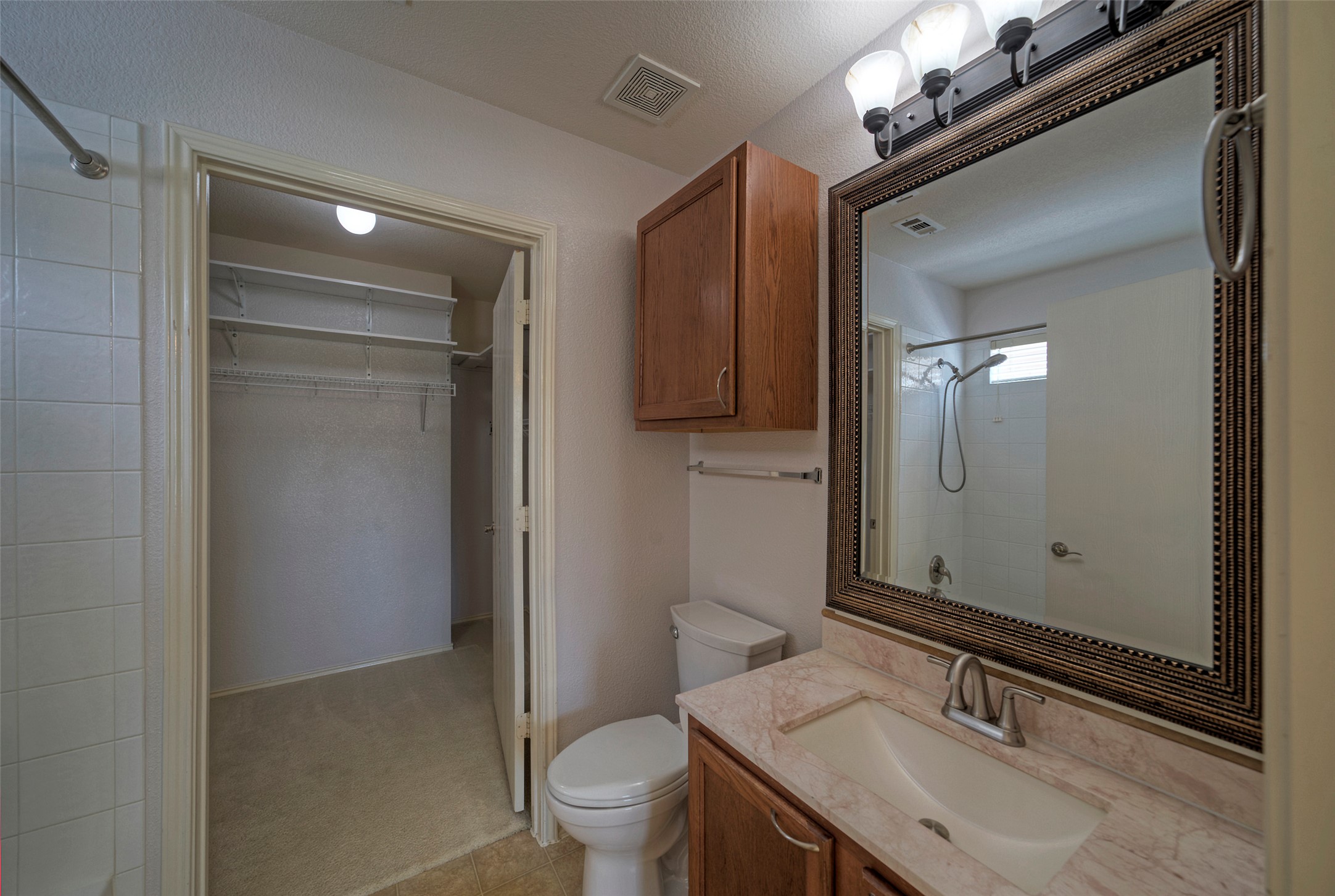 18100 Belfry Pass Manor, TX 78653 - Photo 15 of 30 a bathroom with a sink a toilet and shower
