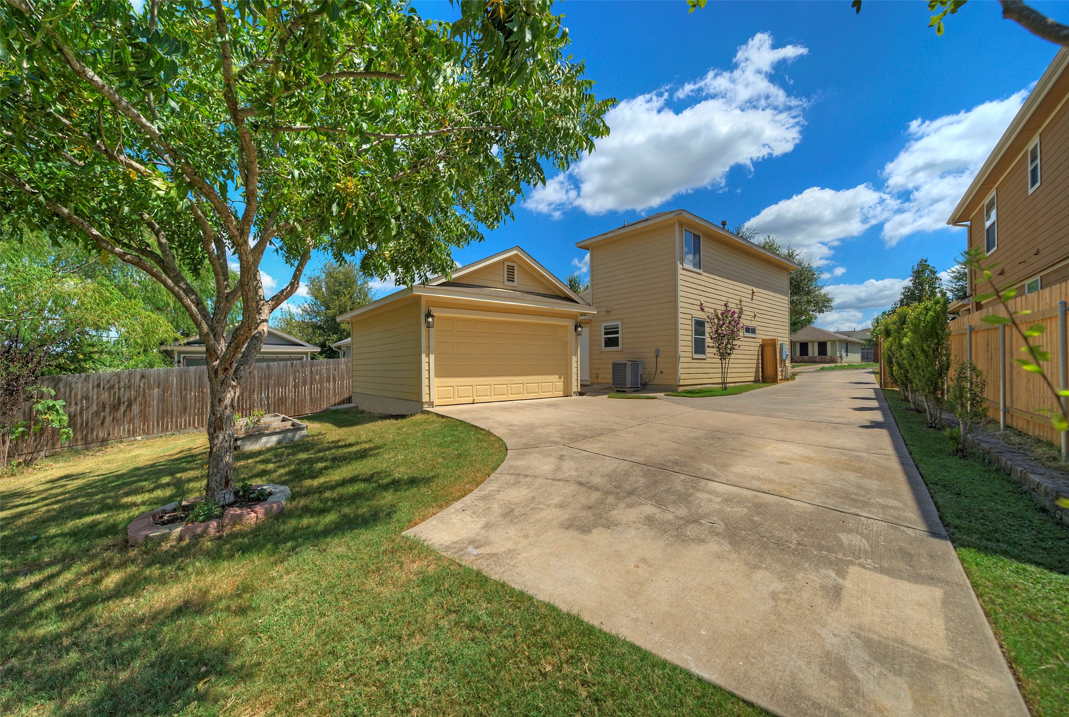 18100 Belfry Pass Manor, TX 78653 - Photo 25 of 30 a front view of a house with a yard and garage