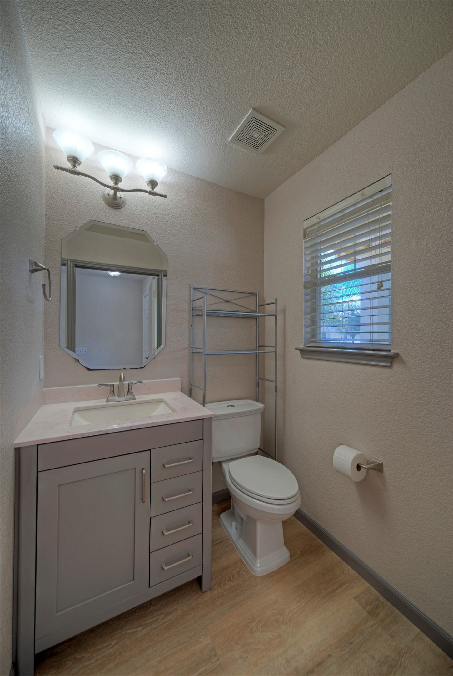 18100 Belfry Pass Manor, TX 78653 - Photo 5 of 30 a bathroom with a toilet sink and mirror