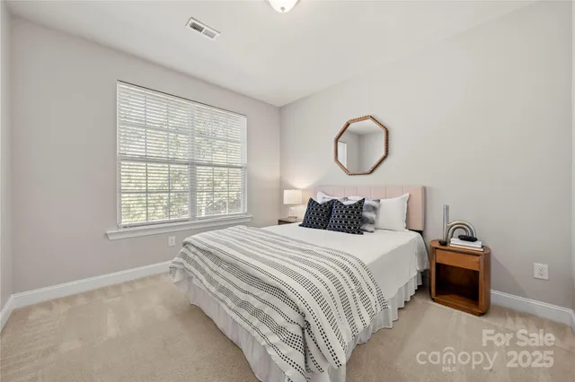 a bedroom with bed and a large window