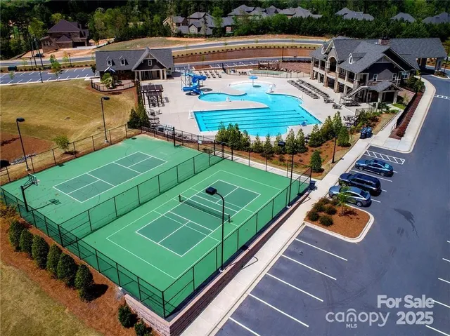 an aerial view of a tennis ground with large trees