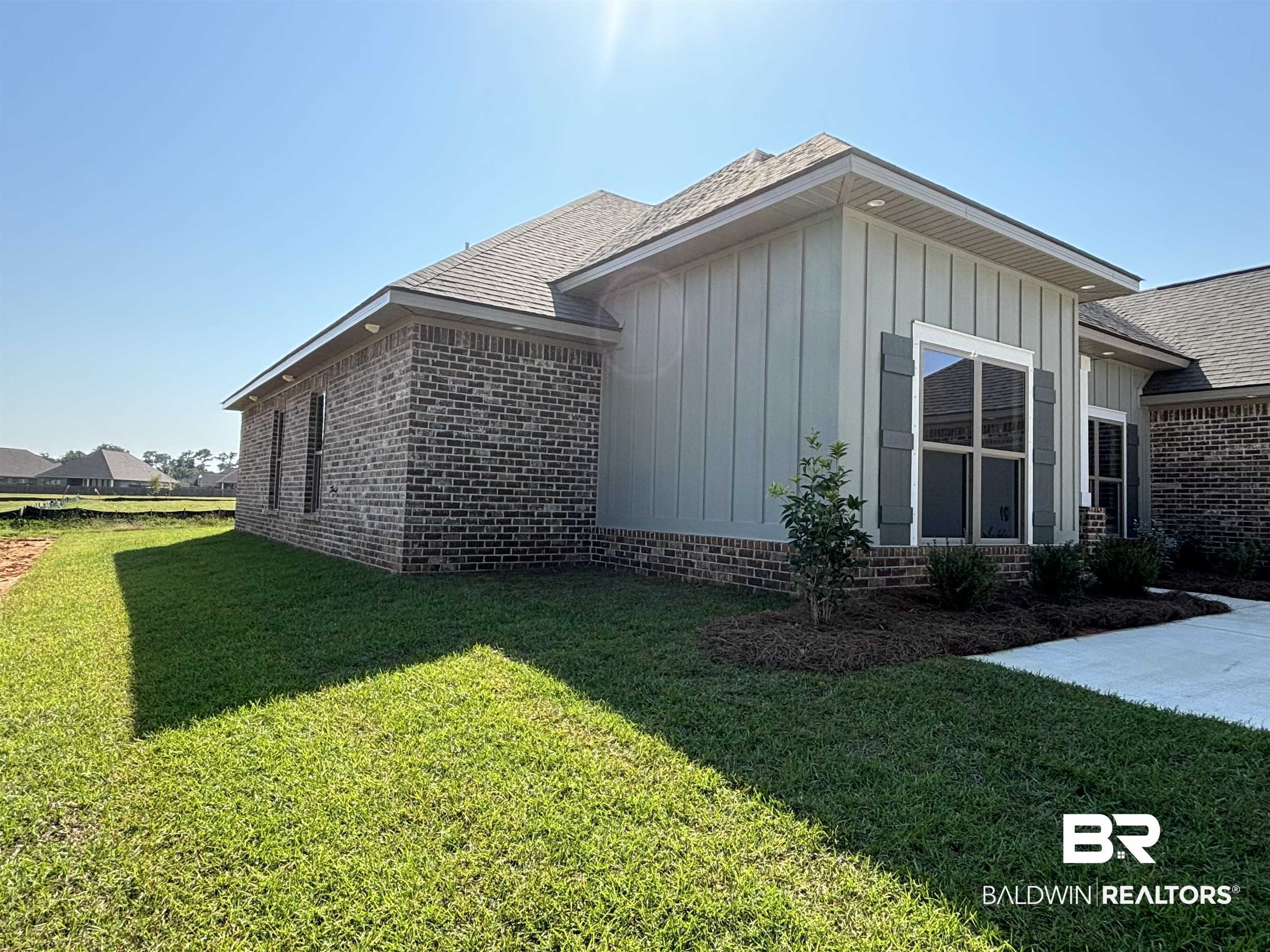 388 Garrison Boulevard Fairhope, AL 36532 - Photo 17 of 34 View of side of property featuring a lawn