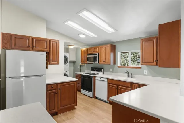 a kitchen with a sink a refrigerator a stove a microwave and cabinets