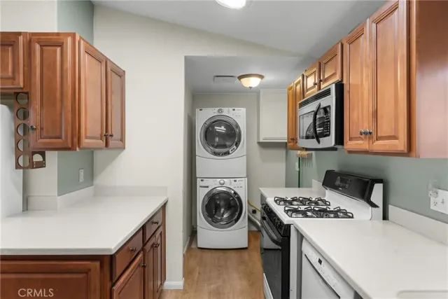 a kitchen with kitchen island a stove a sink and a refrigerator with wooden cabinets