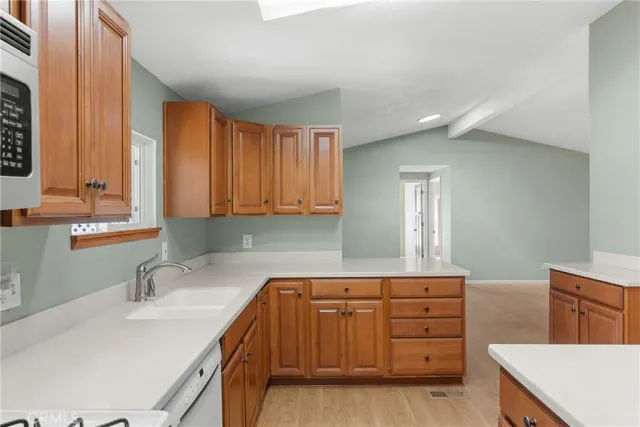 a kitchen with a sink a stove and cabinets
