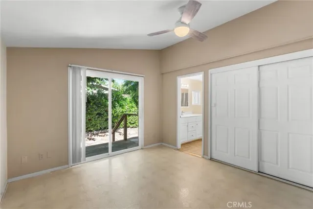 an empty room with windows and closet