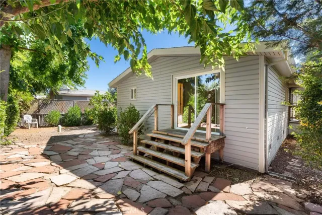 a view of a chair and tables in the backyard of the house