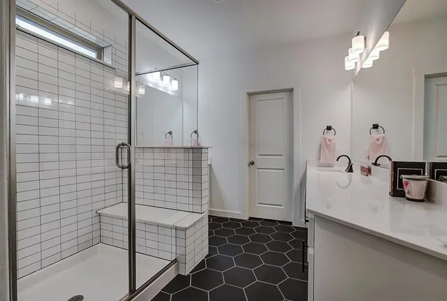 a bathroom with a sink and a mirror with bathtub