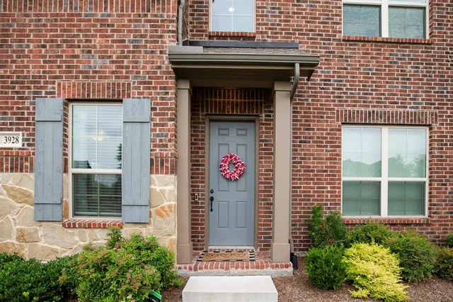 a building with potted plants in front of door