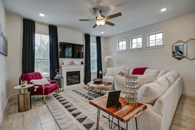 a living room with furniture a flat screen tv and a fireplace