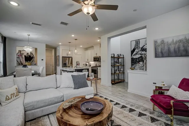 a living room with furniture and a chandelier