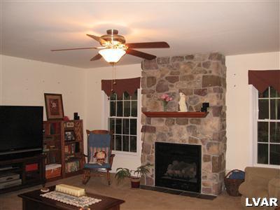 2 Long Mountain Road Effort, PA 18330 - Photo 5 of 12 a living room with furniture a fireplace and a flat screen tv