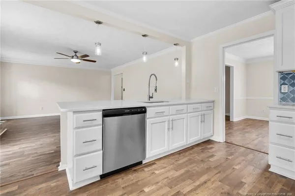 a kitchen with granite countertop a sink and cabinets
