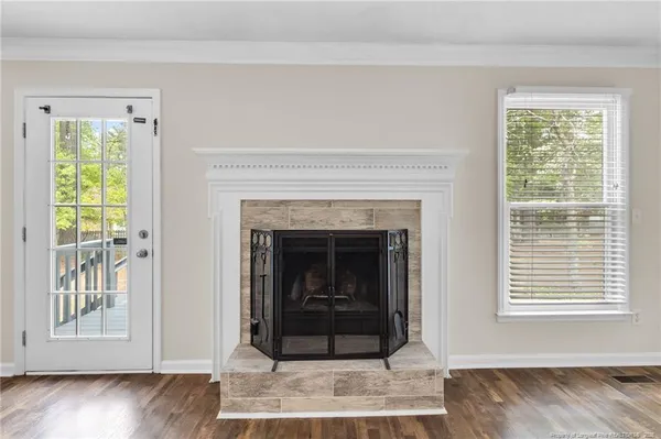 a living room with a fireplace and a wooden floor