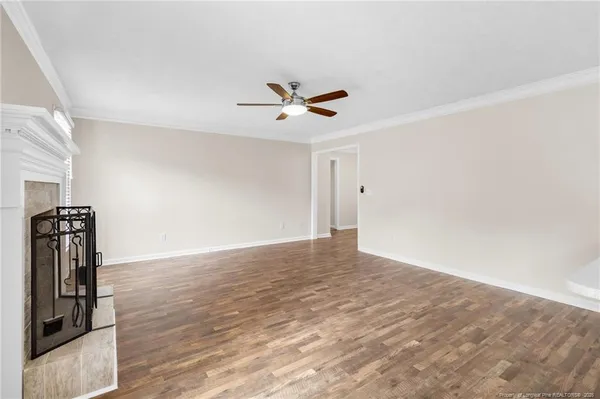 a view of a livingroom with a ceiling fan and wooden floor