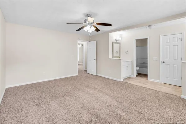 a view of empty room with ceiling fan