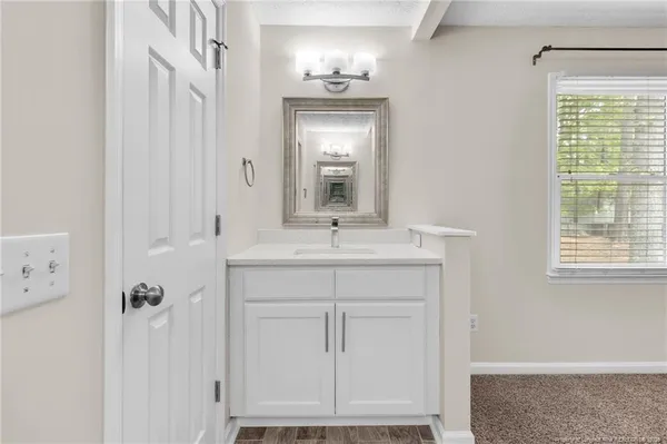 a bathroom with a sink a mirror and a vanity